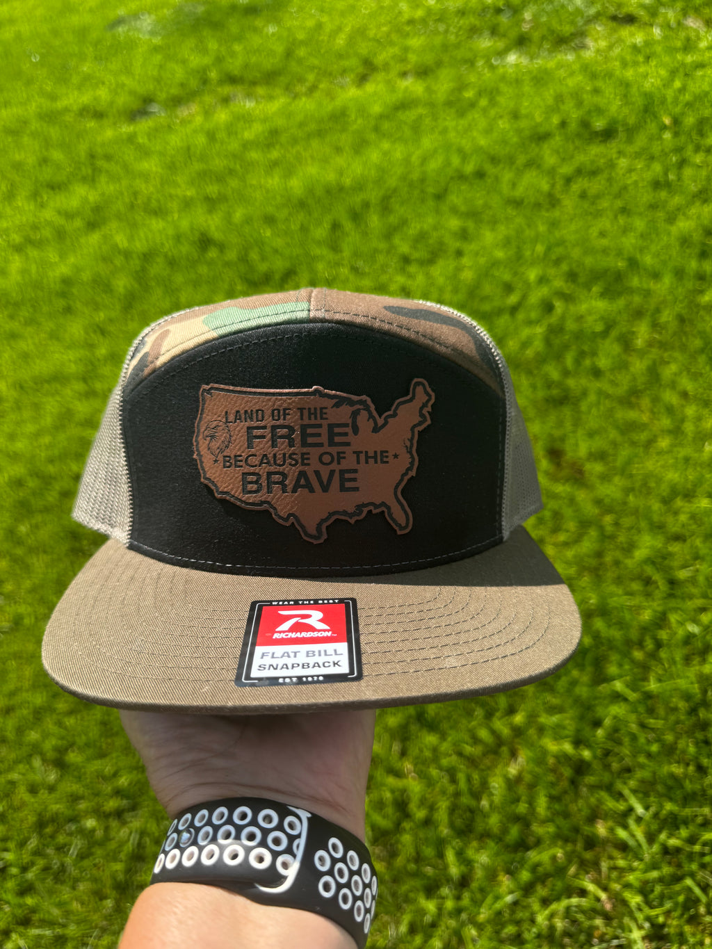 LAND OF THE FREE BECAUSE OF THE BRAVE LEATHER PATCH RICHARDSON 168 FLAT BILL CAMO TRUCKER HAT