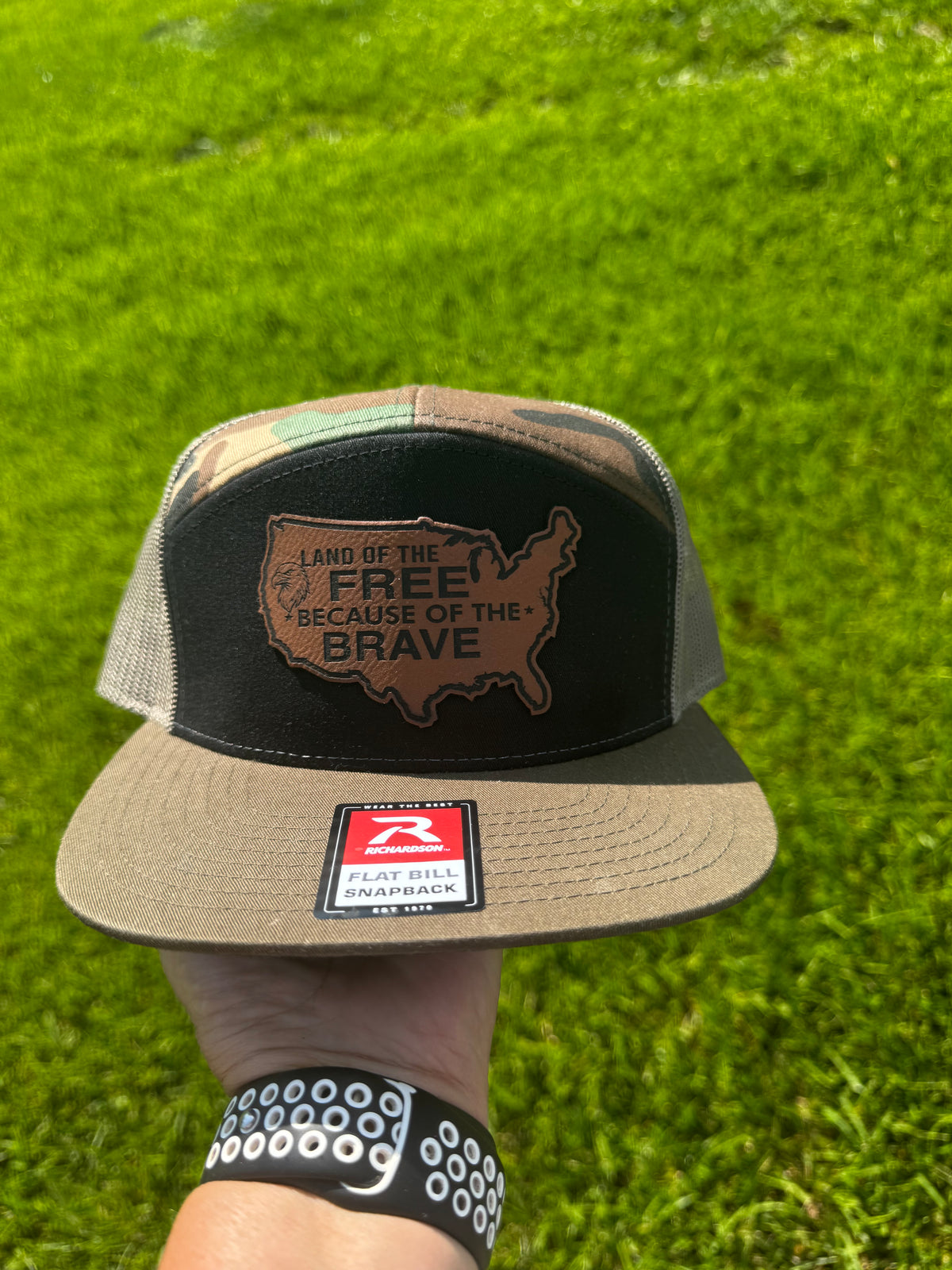 LAND OF THE FREE BECAUSE OF THE BRAVE LEATHER PATCH RICHARDSON 168 FLAT BILL CAMO TRUCKER HAT