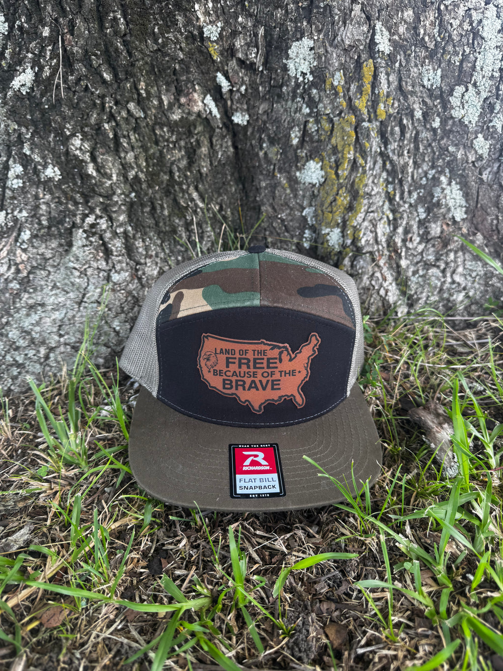 LAND OF THE FREE BECAUSE OF THE BRAVE LEATHER PATCH RICHARDSON 168 FLAT BILL CAMO TRUCKER HAT