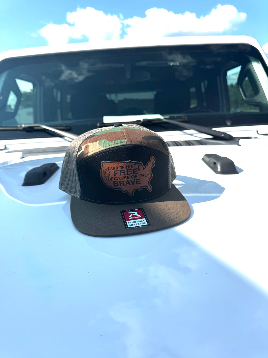 LAND OF THE FREE BECAUSE OF THE BRAVE LEATHER PATCH RICHARDSON 168 FLAT BILL CAMO TRUCKER HAT